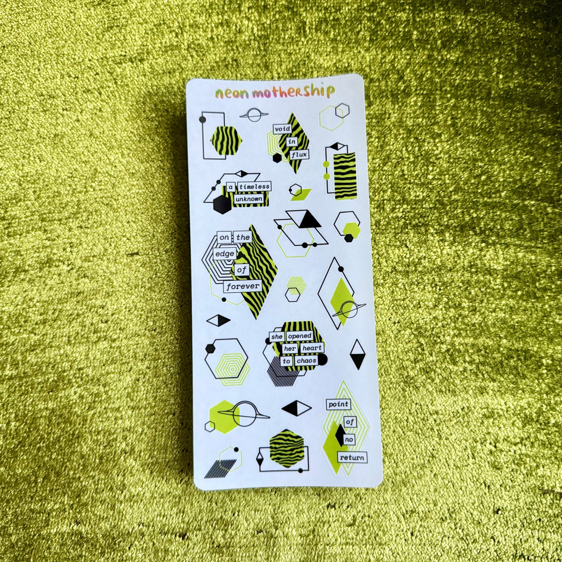 Pack of stickers with geometric designs on a textured green surface