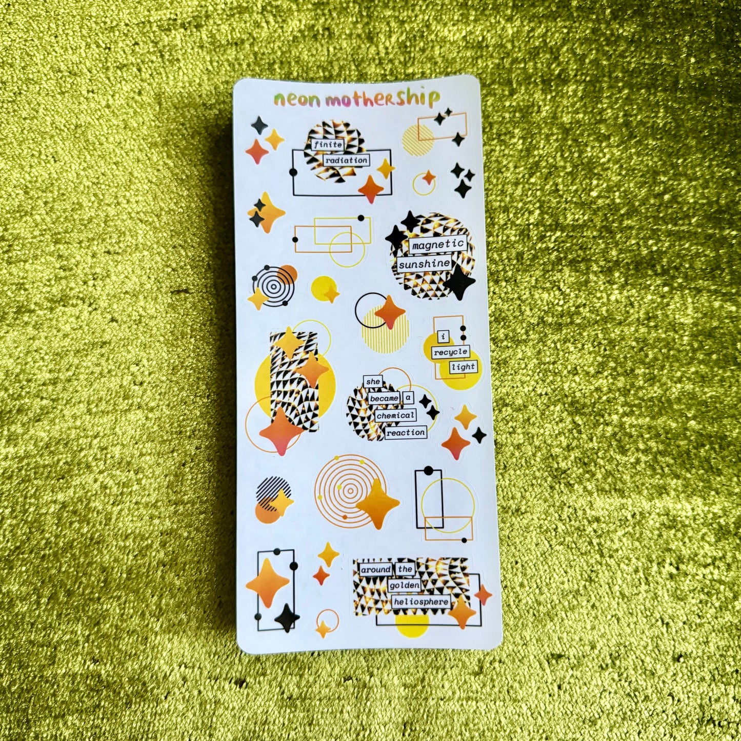 geometric sticker sheet on a green textured background