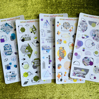 Five sheets of decorative stickers with geometric and abstract designs on a green textured surface.