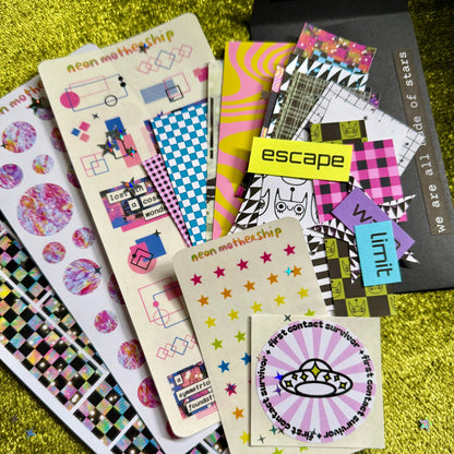 Collection of colorful stickers on a green textured surface