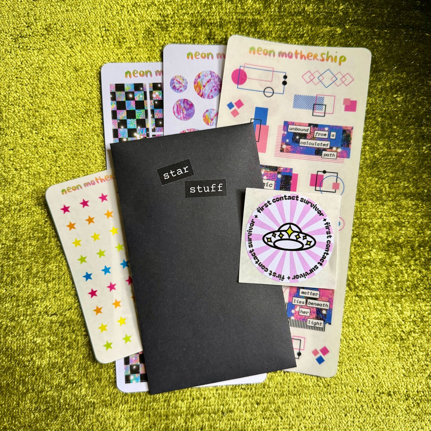 Set of colorful stickers on a green textured surface
