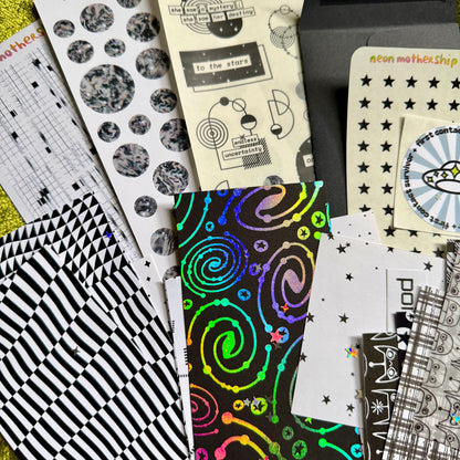 Collection of patterned paper sheets with various designs on a yellow textured background
