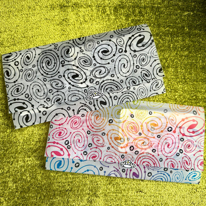 Two patterned vellum envelopes on a textured yellow surface