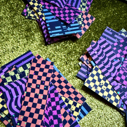 stacks of colorful sticker scraps on a green background