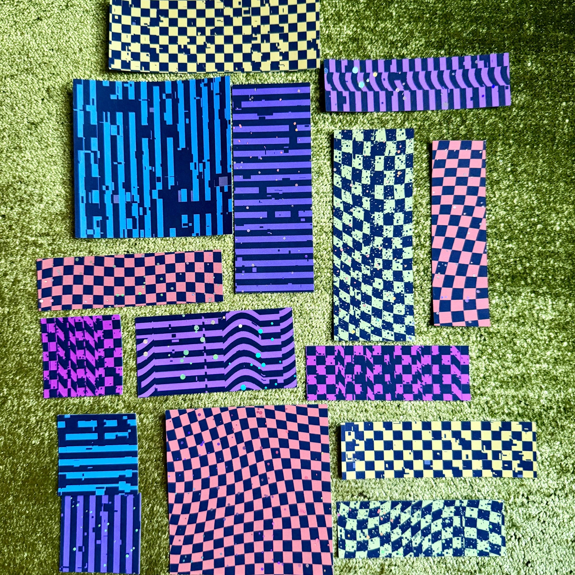 colorful sticker scraps on a green background