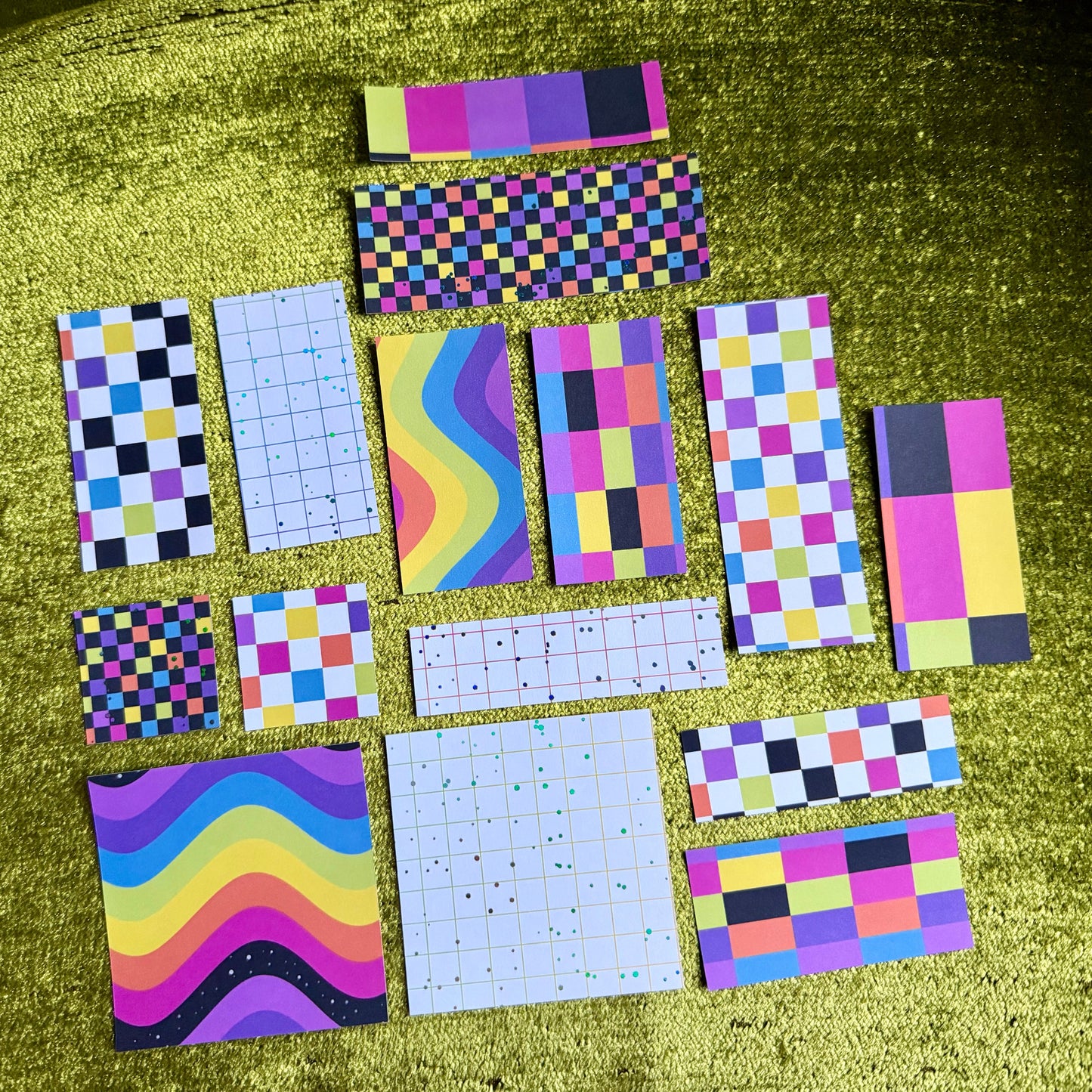 colorful sticker scraps on a green background