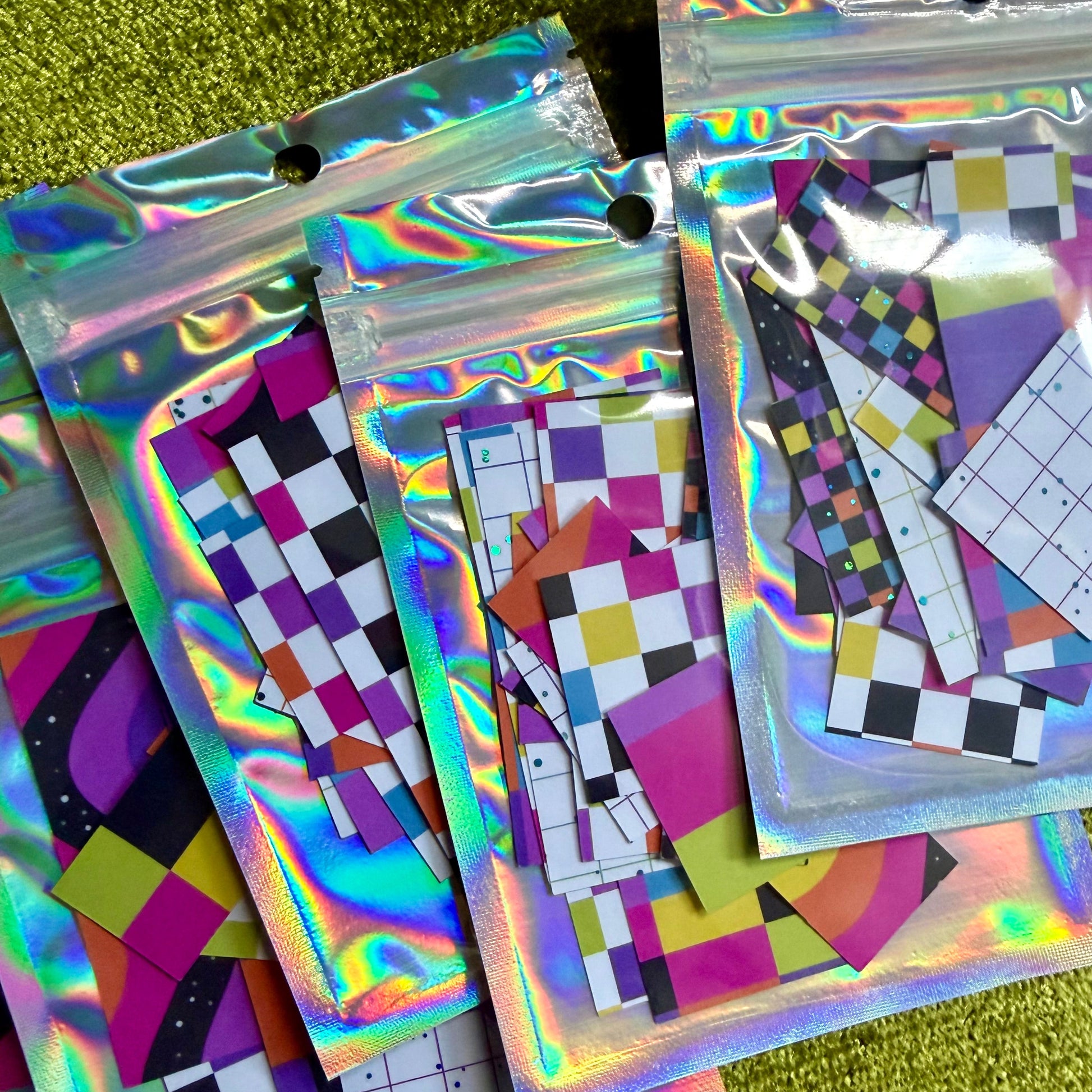 several small packages of sticker scraps on a green background