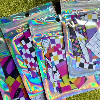 several small packages of sticker scraps on a green background