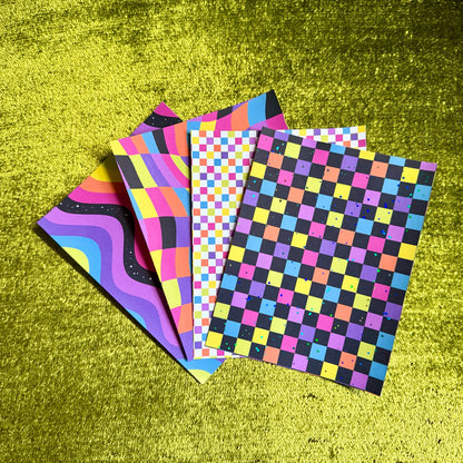 four colorful sticker sheets on a green background