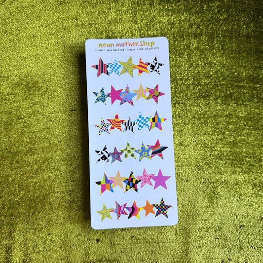 white sticker sheet with colorful star-shaped stickers on a green textured surface