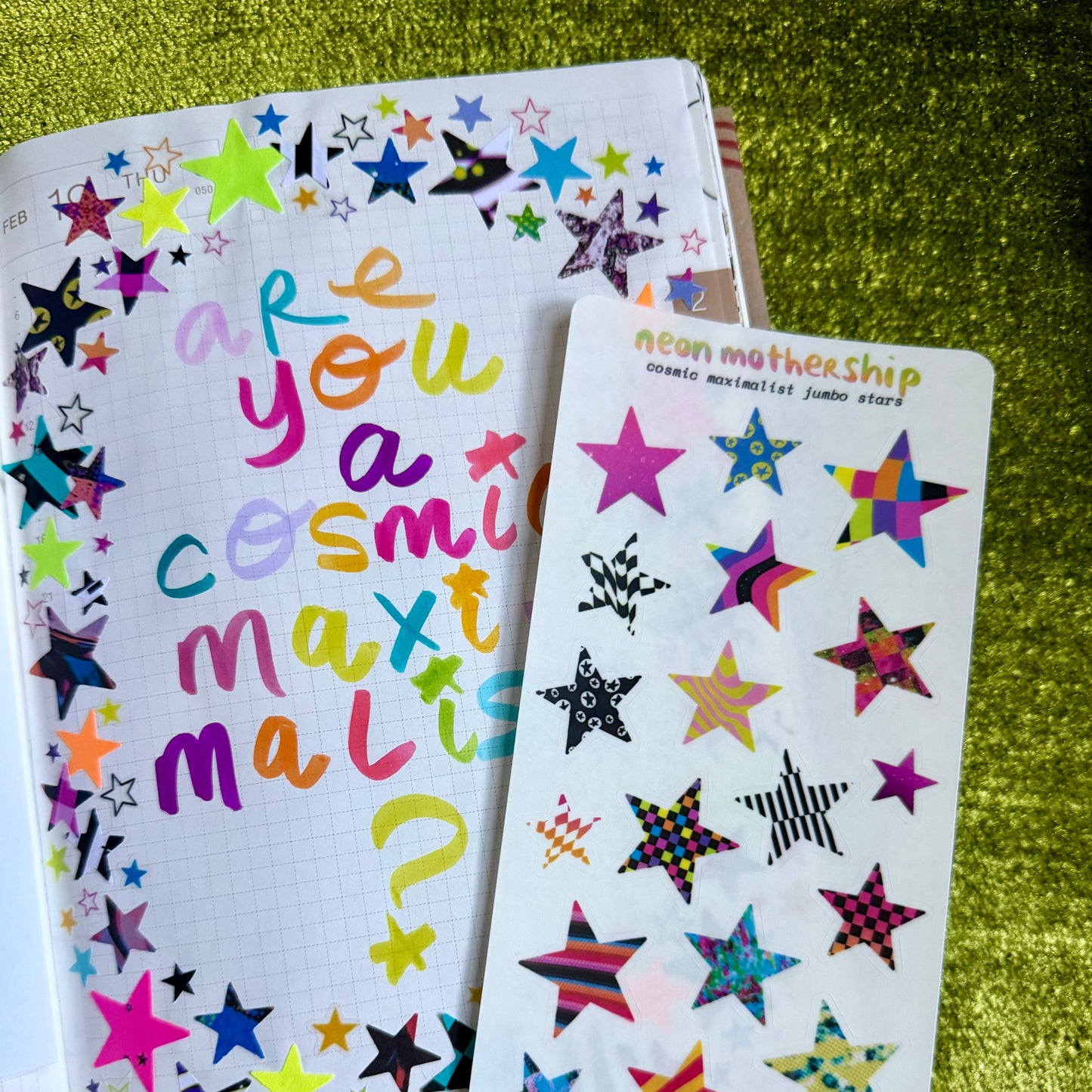 Colorful star-shaped stickers on a green textured surface