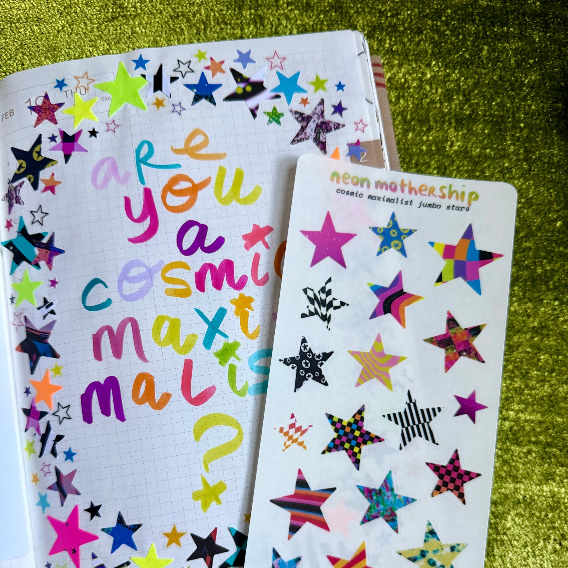 Colorful star-shaped stickers on a green textured surface