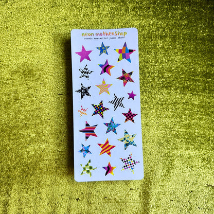 Sticker sheet with colorful star designs on a green textured surface