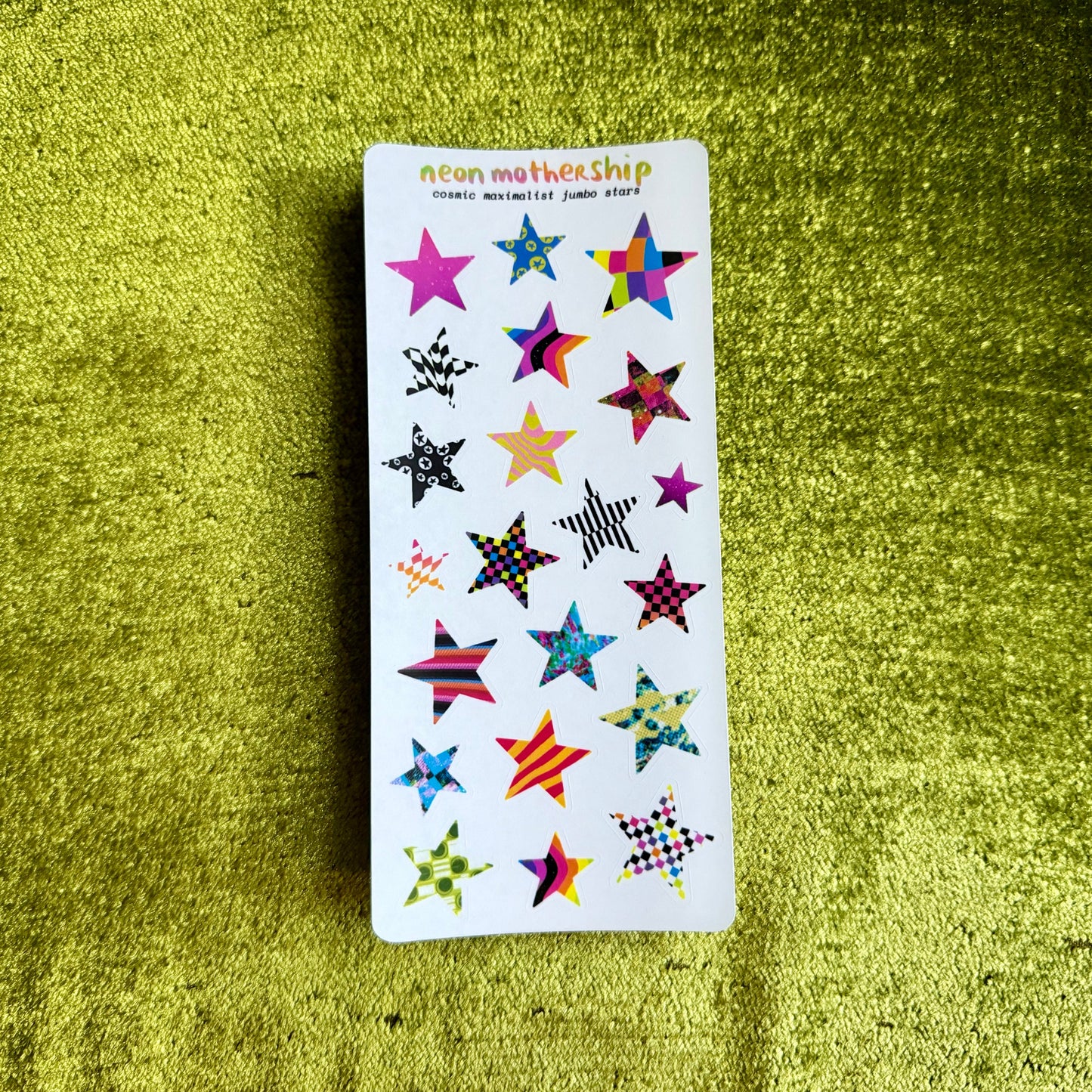 Pack of star-shaped stickers on a green textured surface