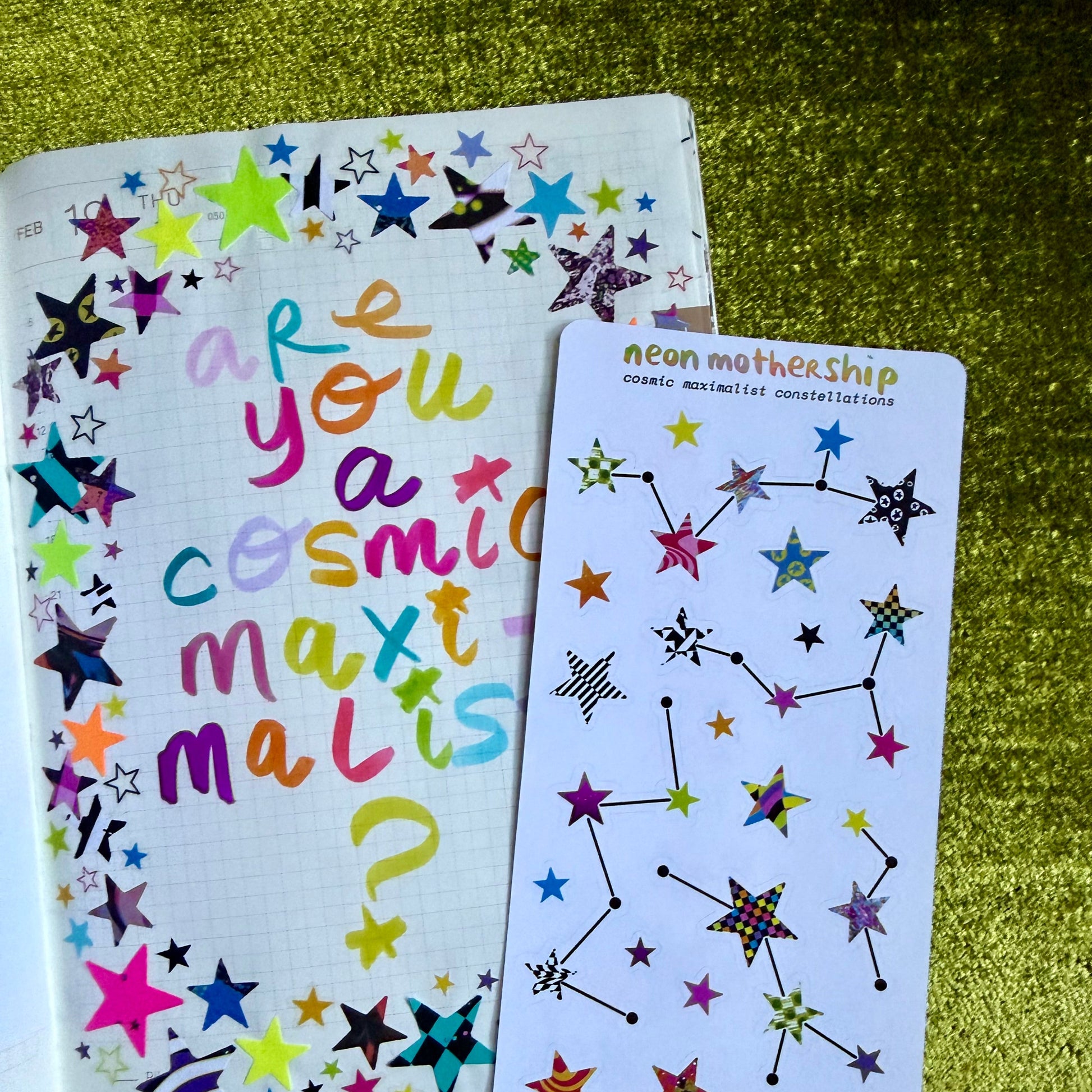 Colorful star-themed sticker sheet and sticker sheet on a green textured surface