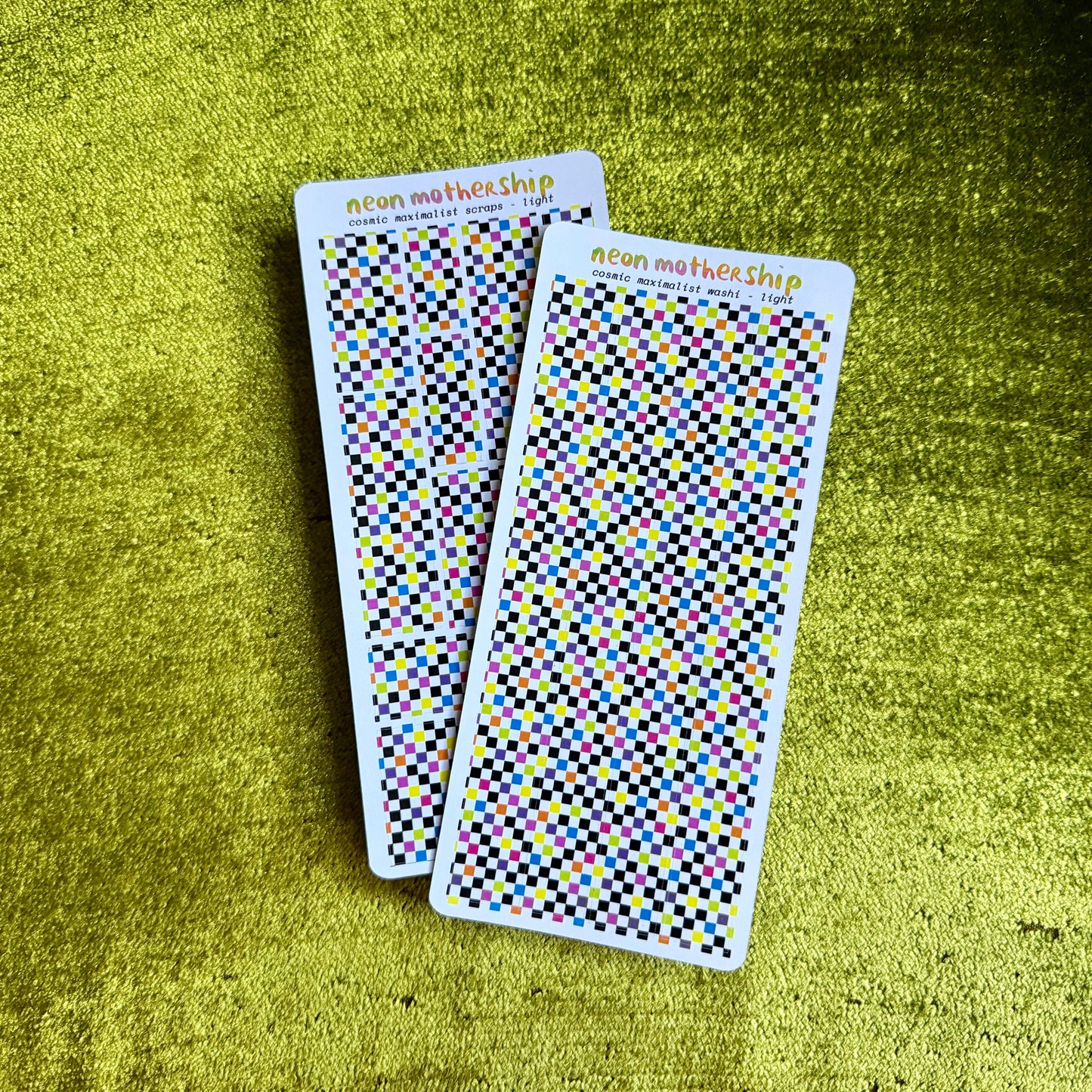 two checkered sticker sheets on a green background