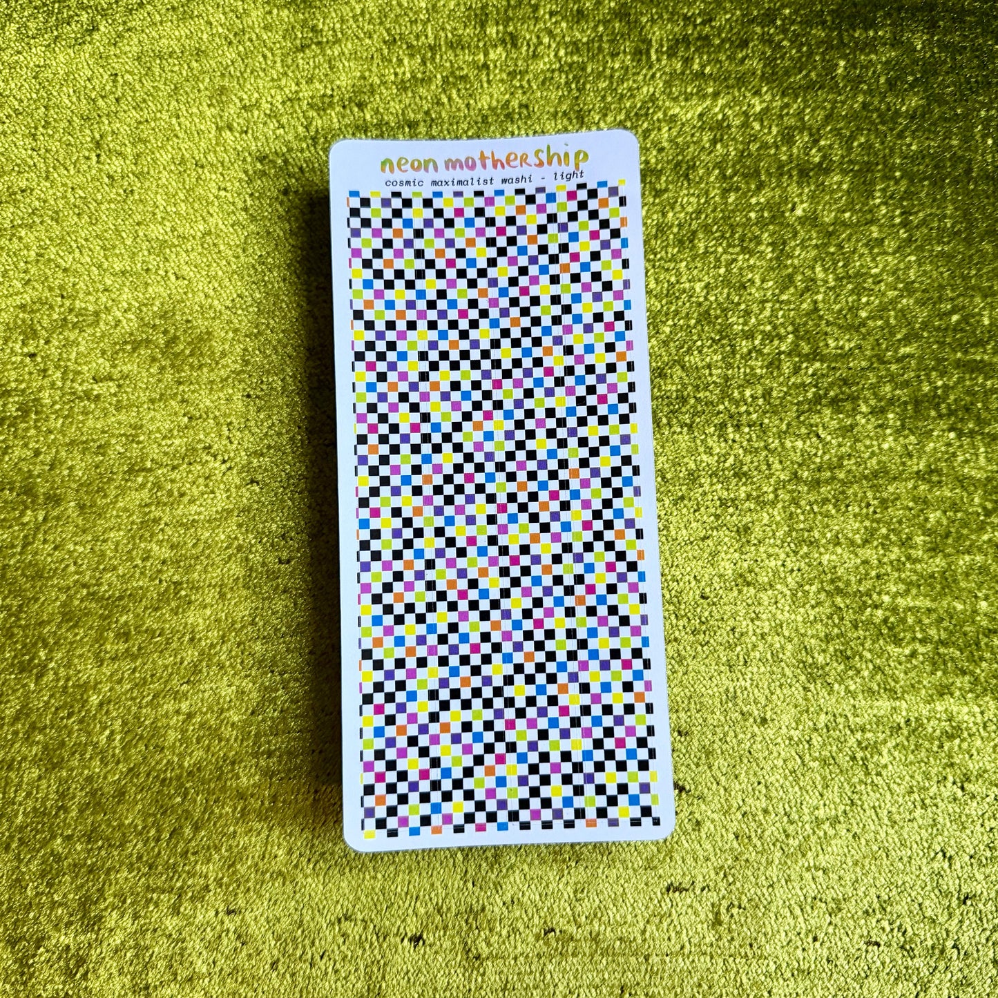 sheet of checkered stickers against a green background