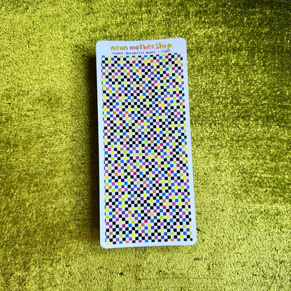 sheet of checkered stickers against a green background