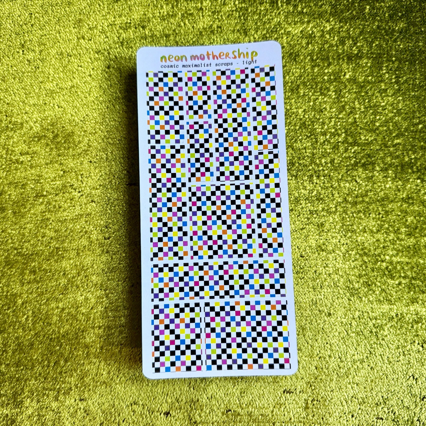 sheet of checkered stickers on a green background
