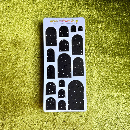sheet of black arch shaped stickers on a green background