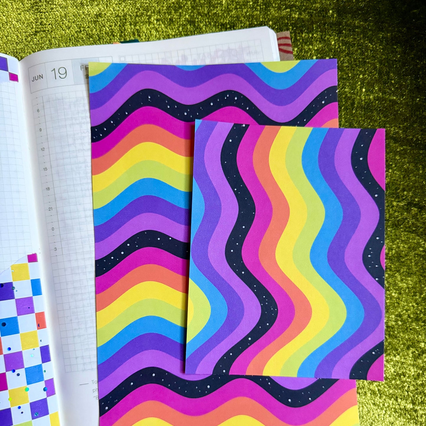 two sheets of rainbow sticker paper on a journal page