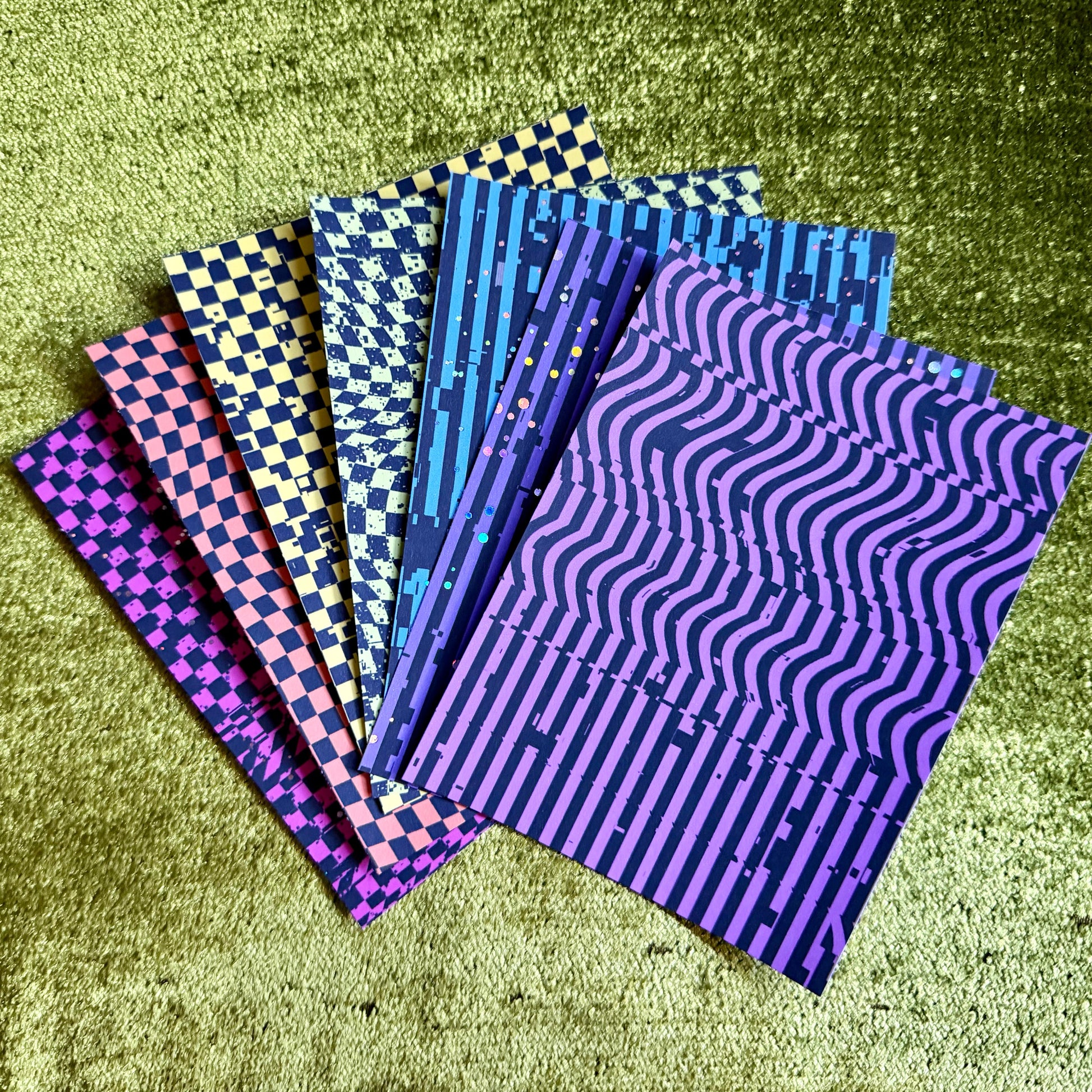colored sticker paper on green background