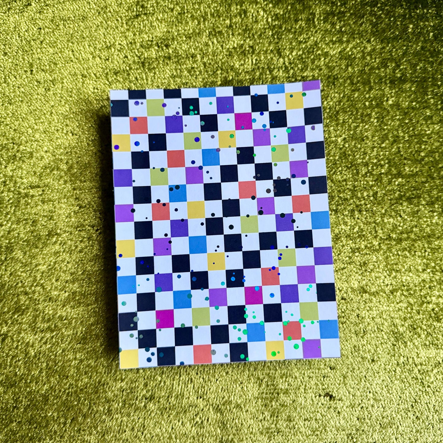 checkered sticker paper on a green background
