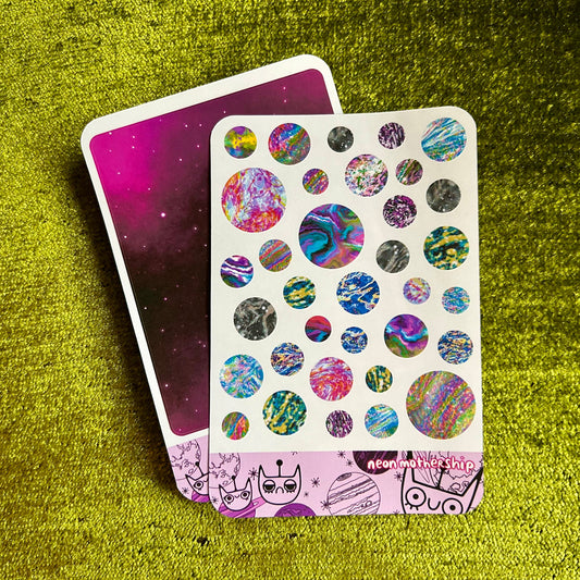 Sticker sheet with colorful circular designs on a green textured surface