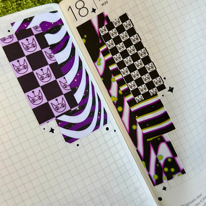 Decorative stickers with black, white, and purple patterns on a planner page.