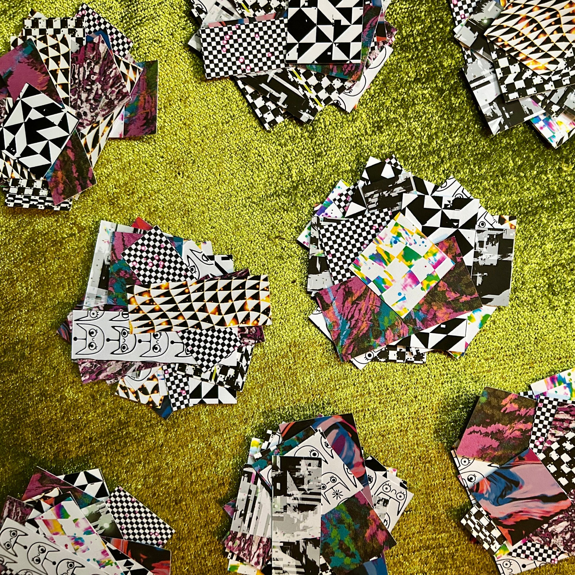 Collage of various patterned sticker scrap squares on a green surface