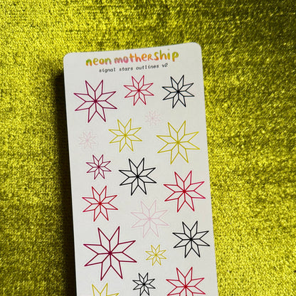 A sticker sheet from the brand 'neon mothership' featuring various outlined star and snowflake designs in pink, yellow, and black on a white backing card, set against a textured yellow background.