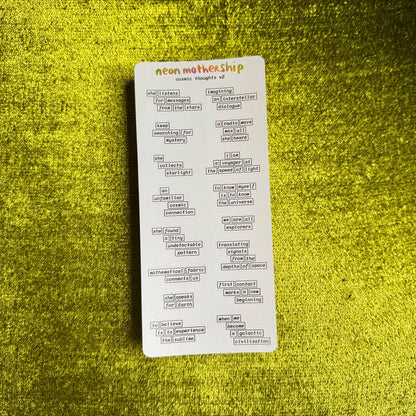 a sticker sheet with cosmic phrases on a green textured background