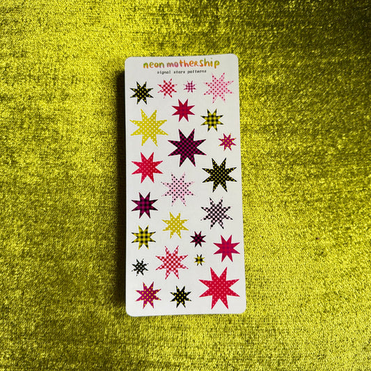 A rectangular sticker sheet from neon mother ship featuring various colorful embroidered star patterns, displayed on a textured yellow background.