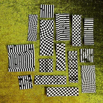 Black and white checkered stickers on a textured green surface