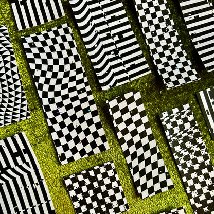 Patterned sticker scraps with black and white geometric designs on a green background