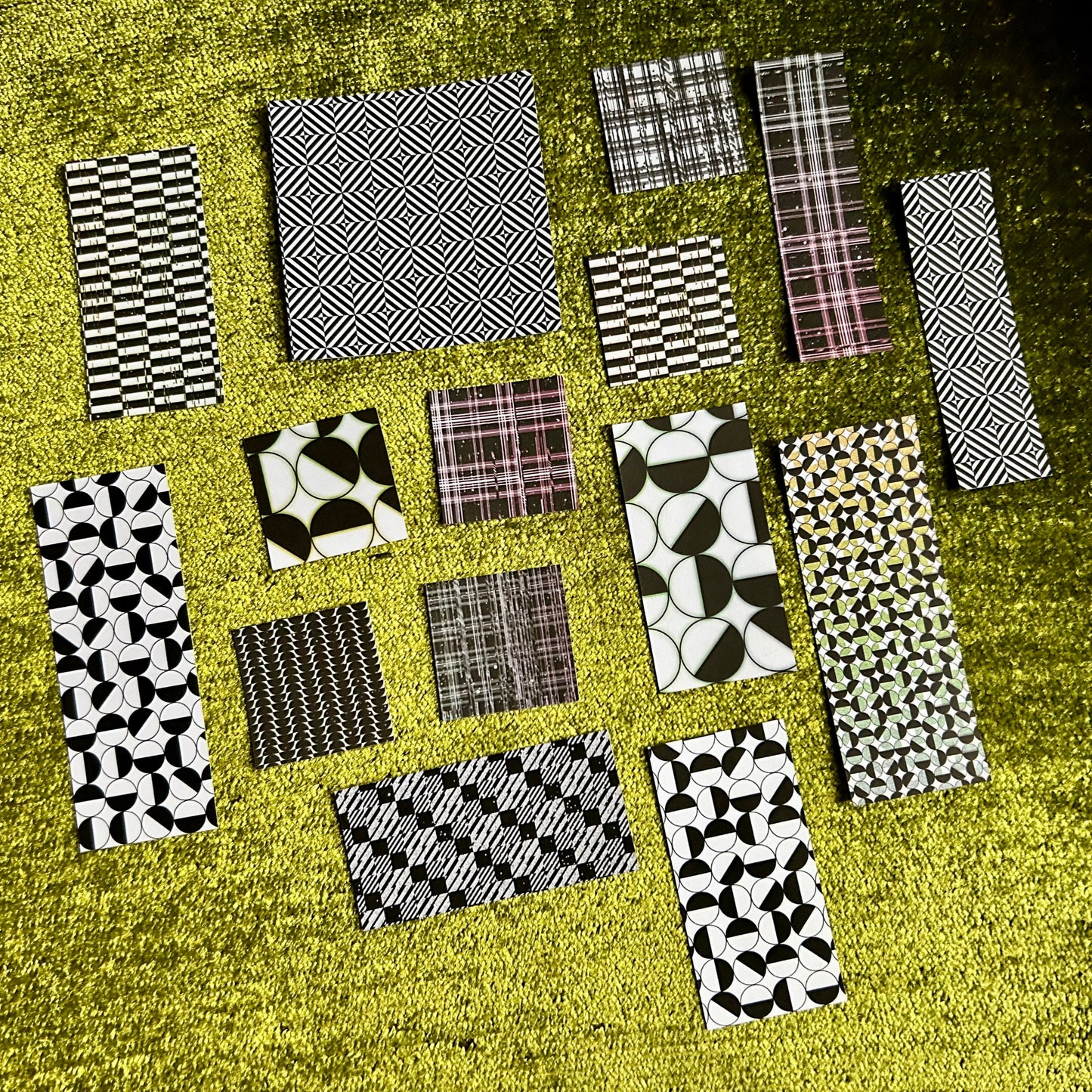Collection of patterned sticker scraps arranged on a textured surface
