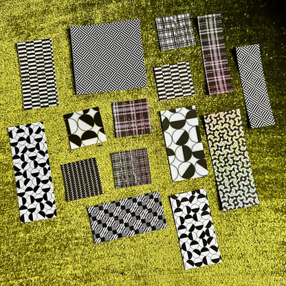 Collection of patterned sticker scraps arranged on a textured surface