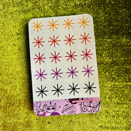 sticker sheet with star patterns on a green textured surface