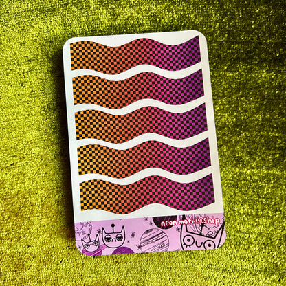 sticker sheet with wavy pattern on a green textured surface