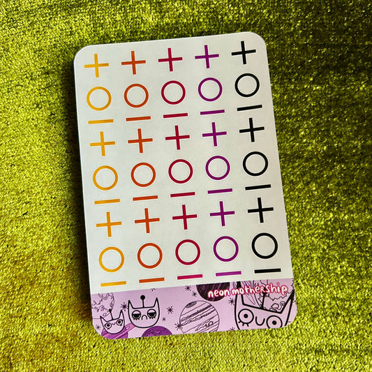 sticker sheet with plus and circle symbols on a green textured surface