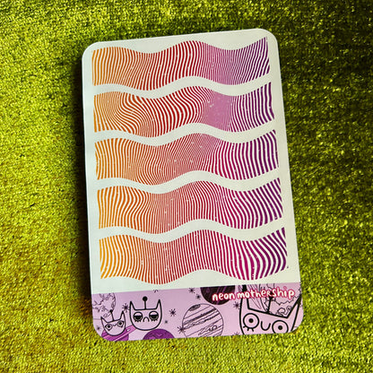 sticker sheet with wavy pattern on a green textured surface