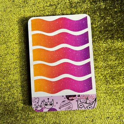 Colorful wavy-patterned sticker sheet on a green textured surface