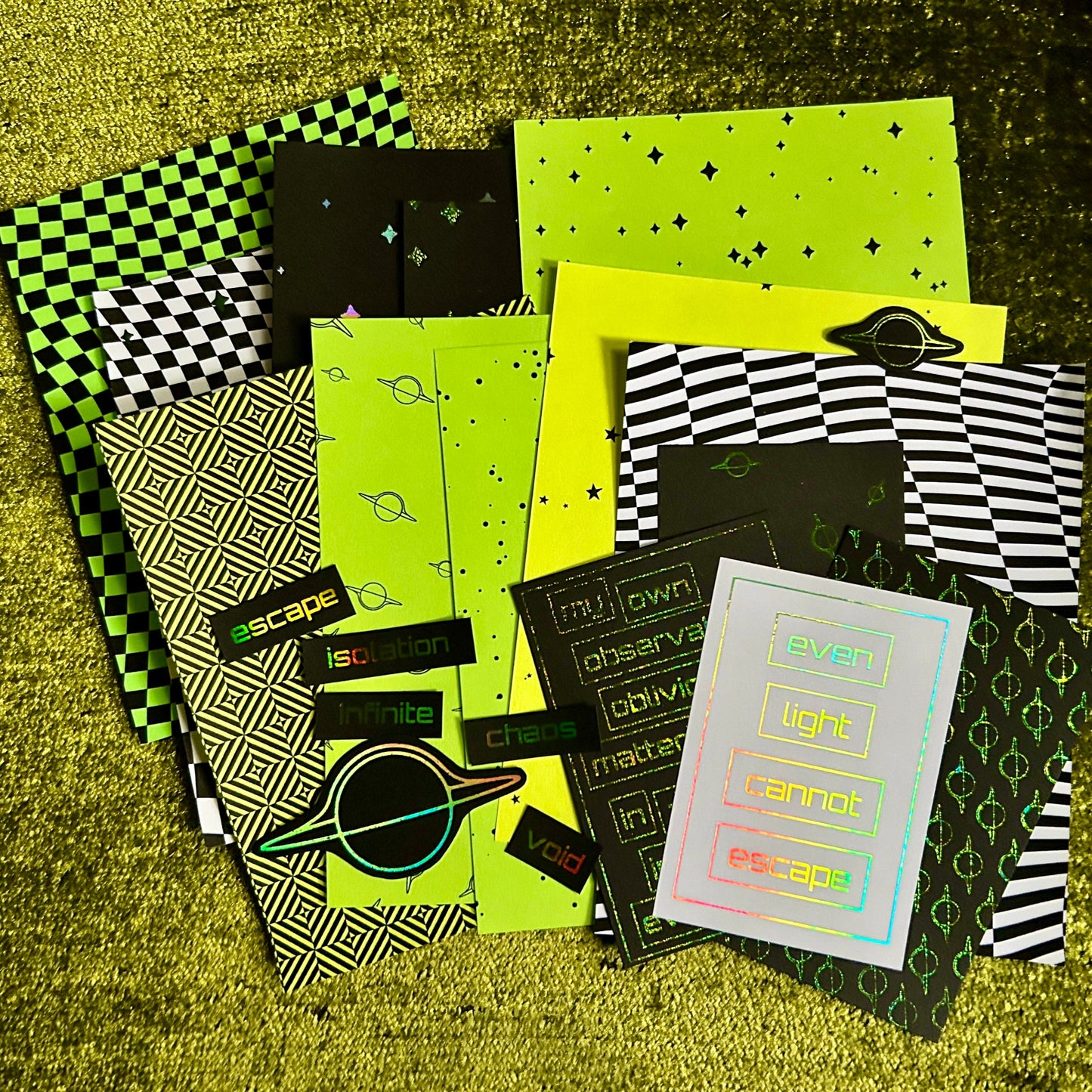 Collection of papers with various patterns on a textured green surface
