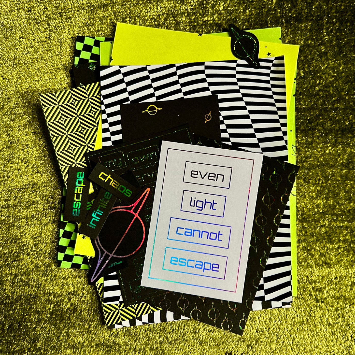 Collection of paper scraps with geometric patterns and text on a textured yellow surface