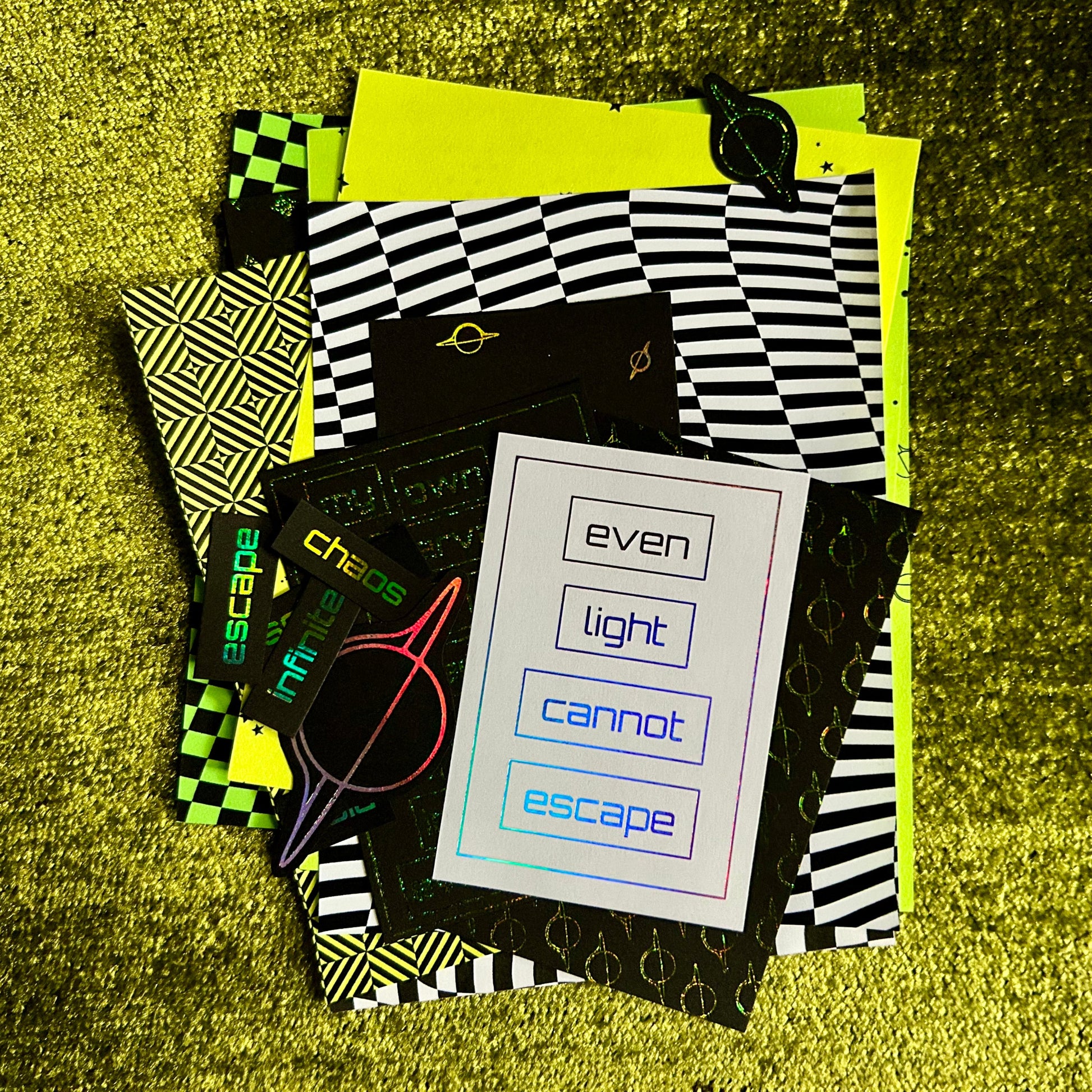 Collection of paper scraps with geometric patterns and text on a textured yellow surface