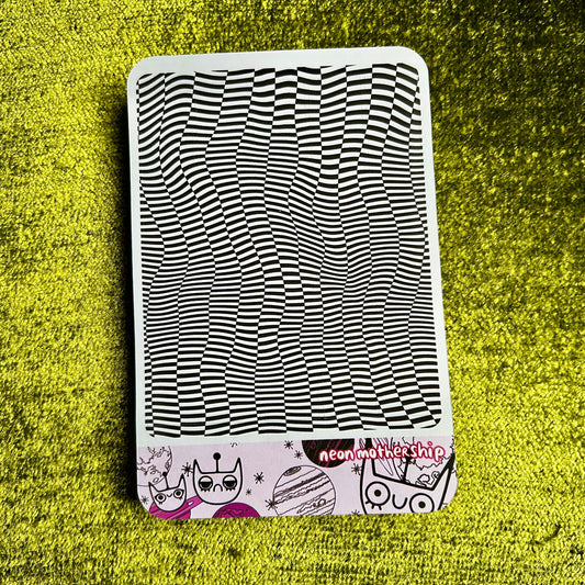 sticker sheet with black and white wavy pattern on a green textured surface