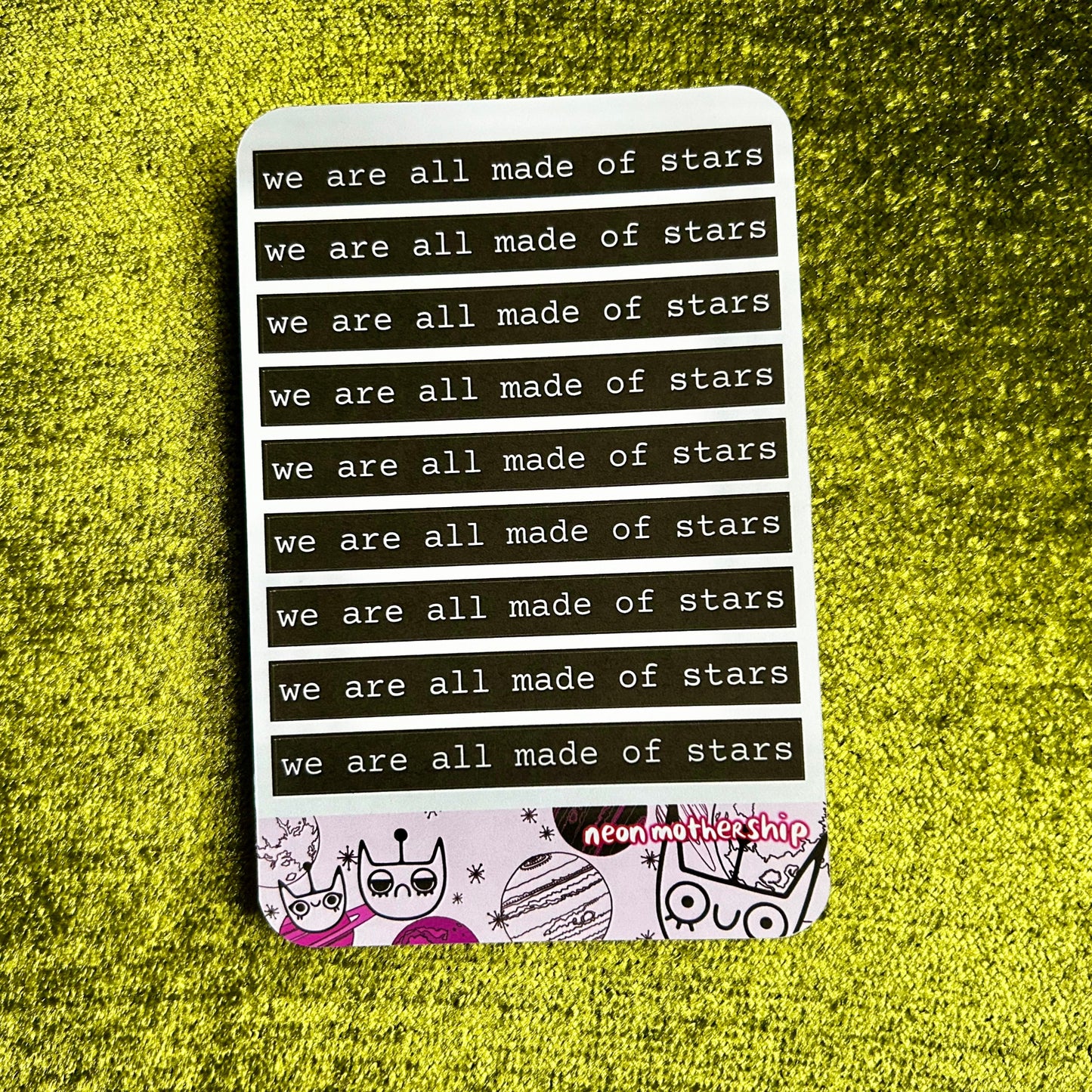 Sticker sheet with 'we are all made of stars' text on a green textured background