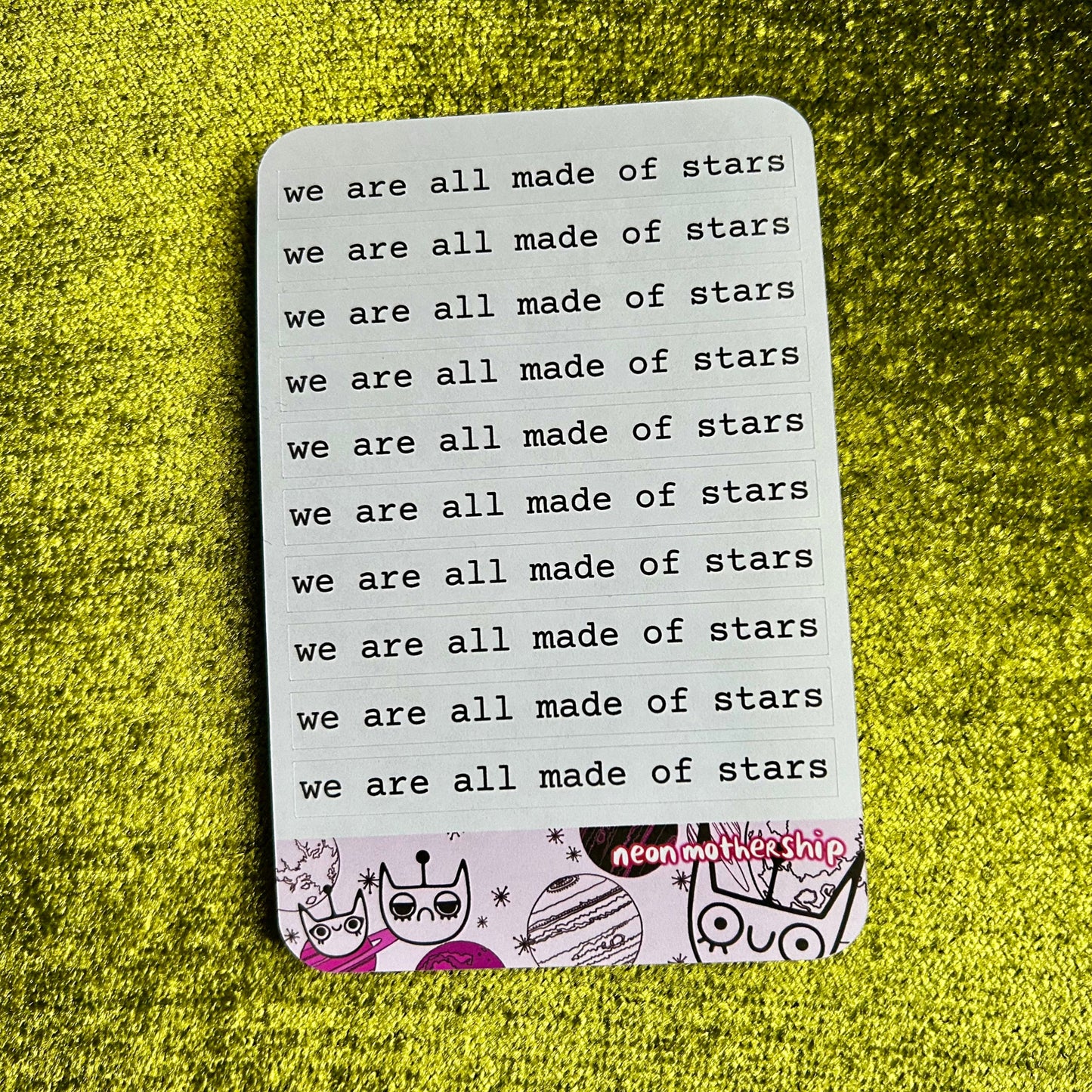 Sticker sheet with 'we are all made of stars' text on a green textured background