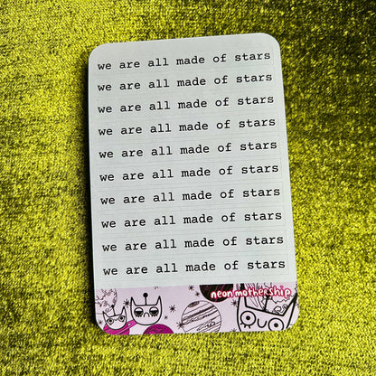 Sticker sheet with 'we are all made of stars' text on a green textured background