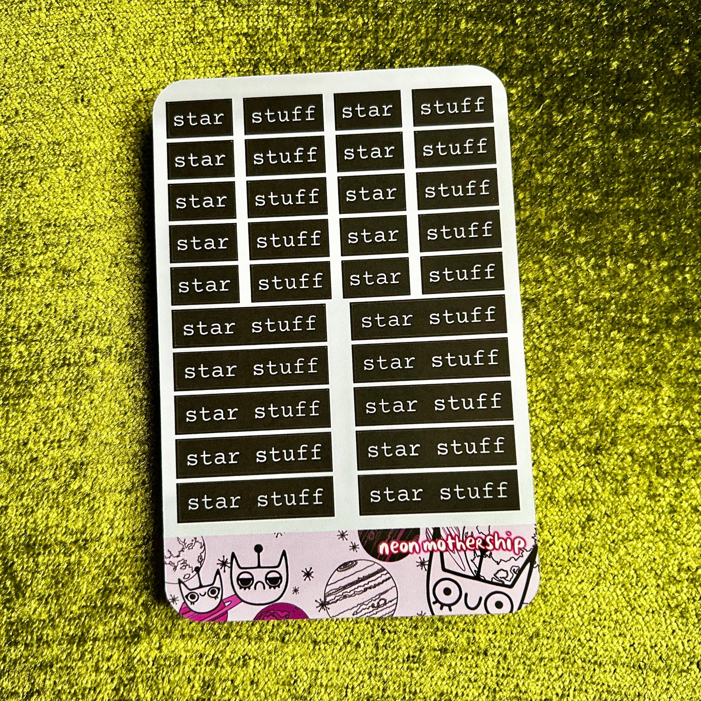 Sticker sheet with 'star stuff' text on a green textured surface